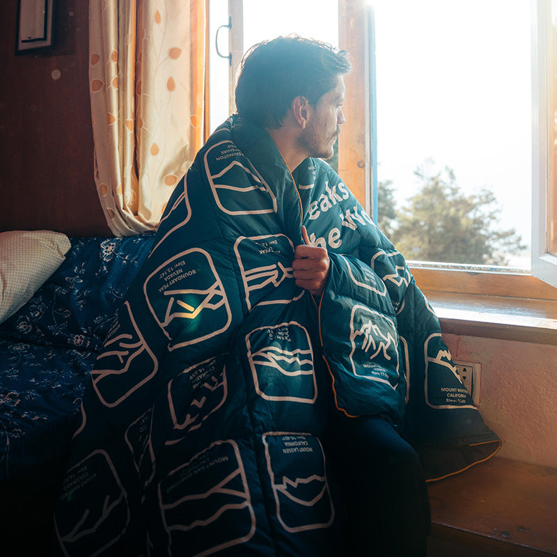 Nomadix Graphene Puffer Blanket: Peaks of the World Teal Ocean